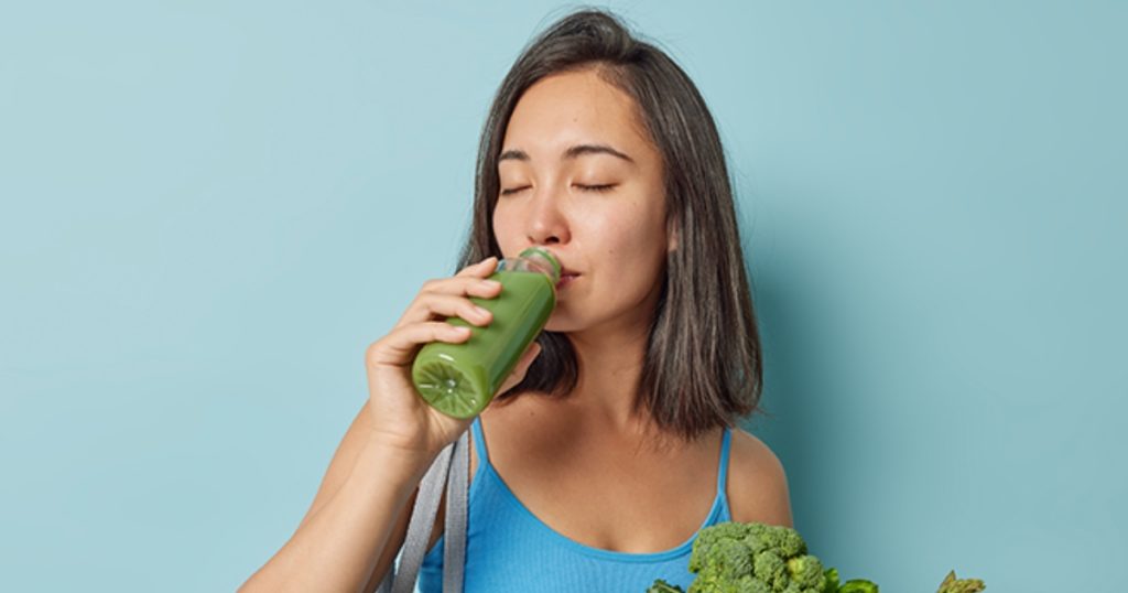 woman drinking healthy smoothie