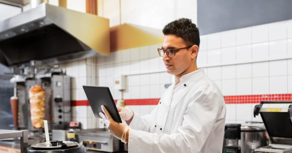 chef using a tablet to follow preparation steps